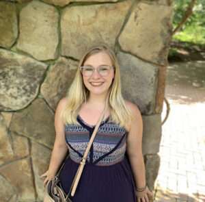 Picture of Rachel standing in front of a stone wall